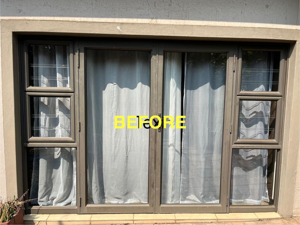 Storefront before aluminium polishing, with aged frames and glass doors