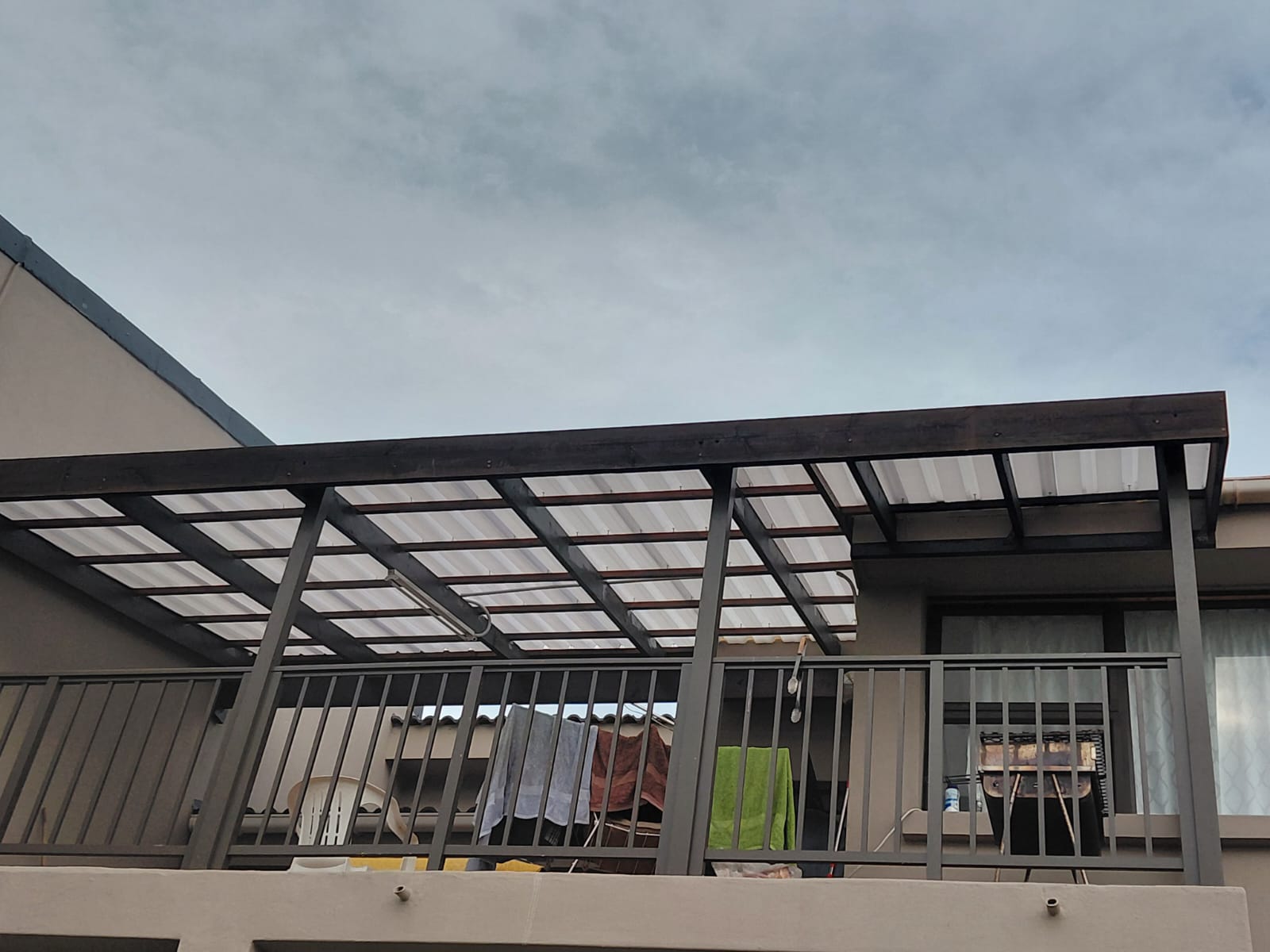 Metal pergola with polycarbonate panels on modern building
