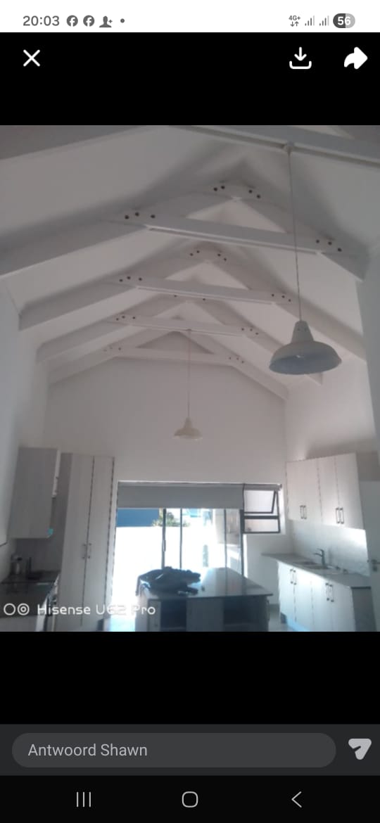 Modern interior with exposed beam ceiling and kitchen
