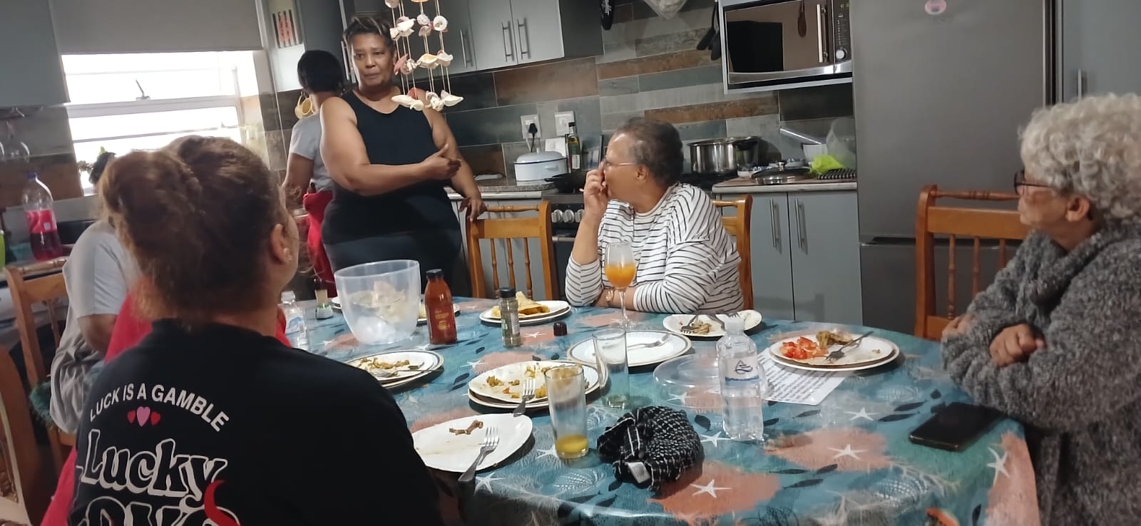 Family gathering around the kitchen table during Ladies' Camp