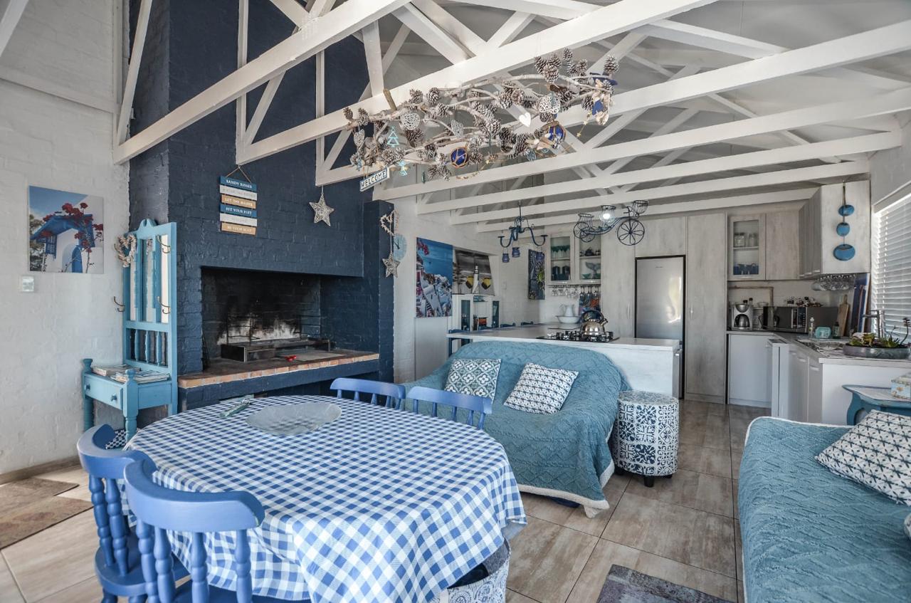 Bright modern coastal retreat interior with blue and white decor and exposed beam ceiling