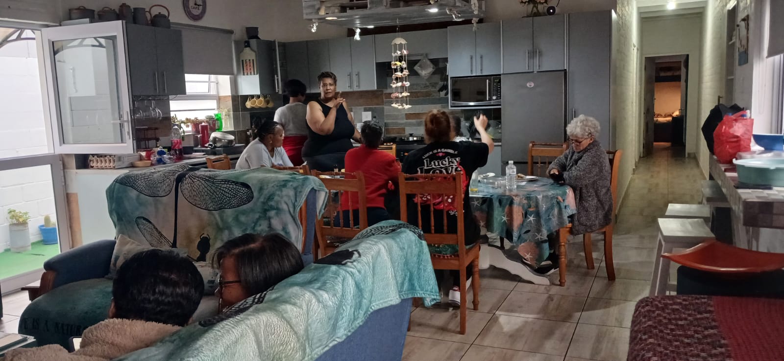 Multi-generational gathering in the kitchen and living space during Ladies' Camp