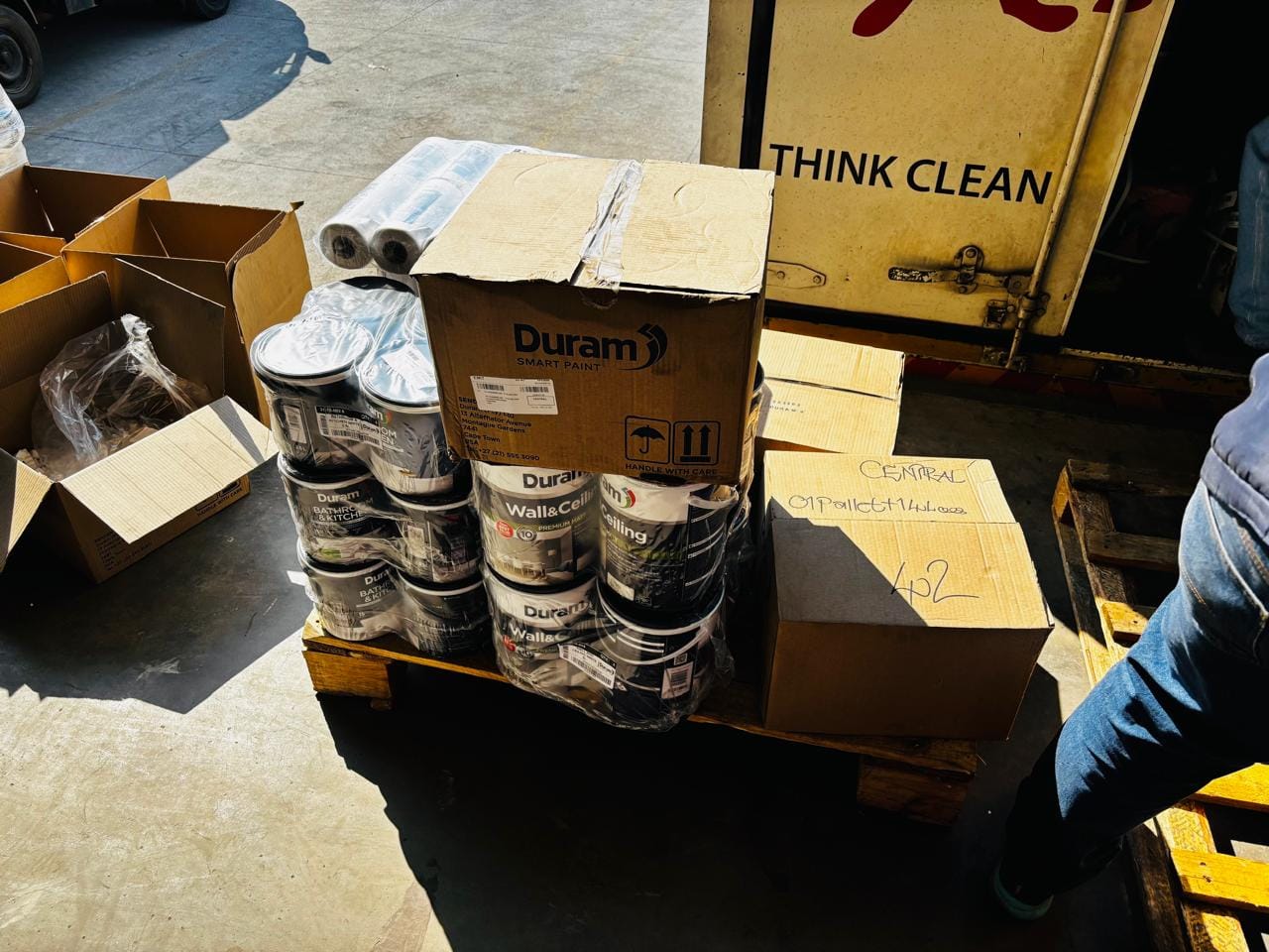 Duram Smart Paint product display stand with paint cans and wall paint boxes at an outdoor market location
