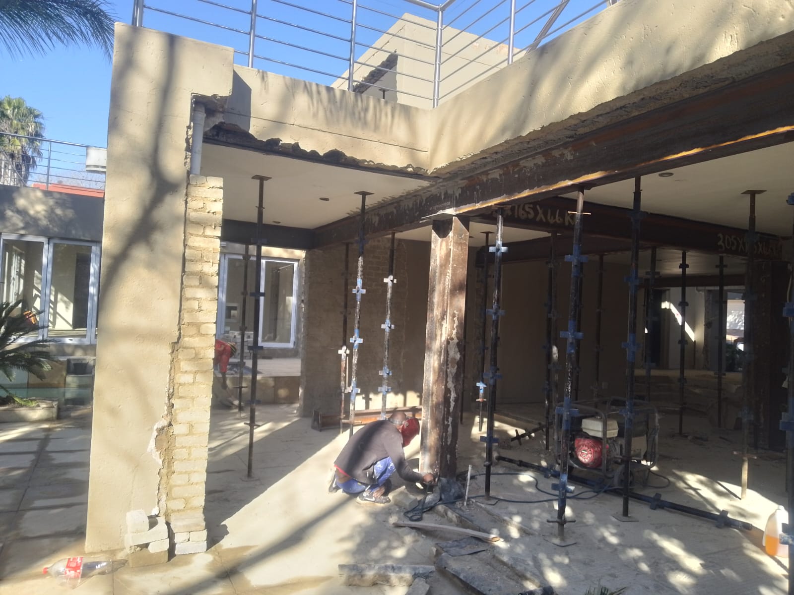 Commercial storefront renovation with exposed brick and steel columns