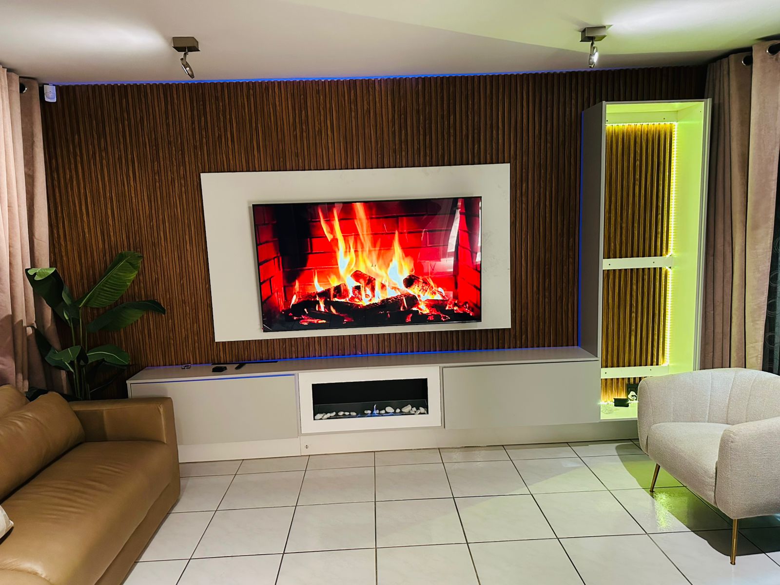 Living room with wall-mounted TV and electric fireplace entertainment unit
