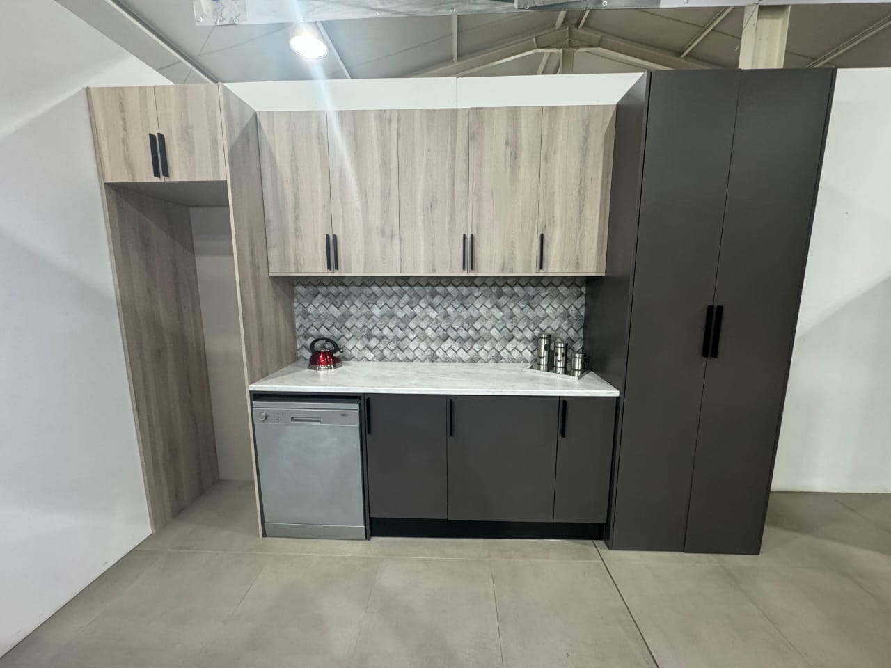 Modern kitchen with light wood upper cabinets and dark lower cabinets