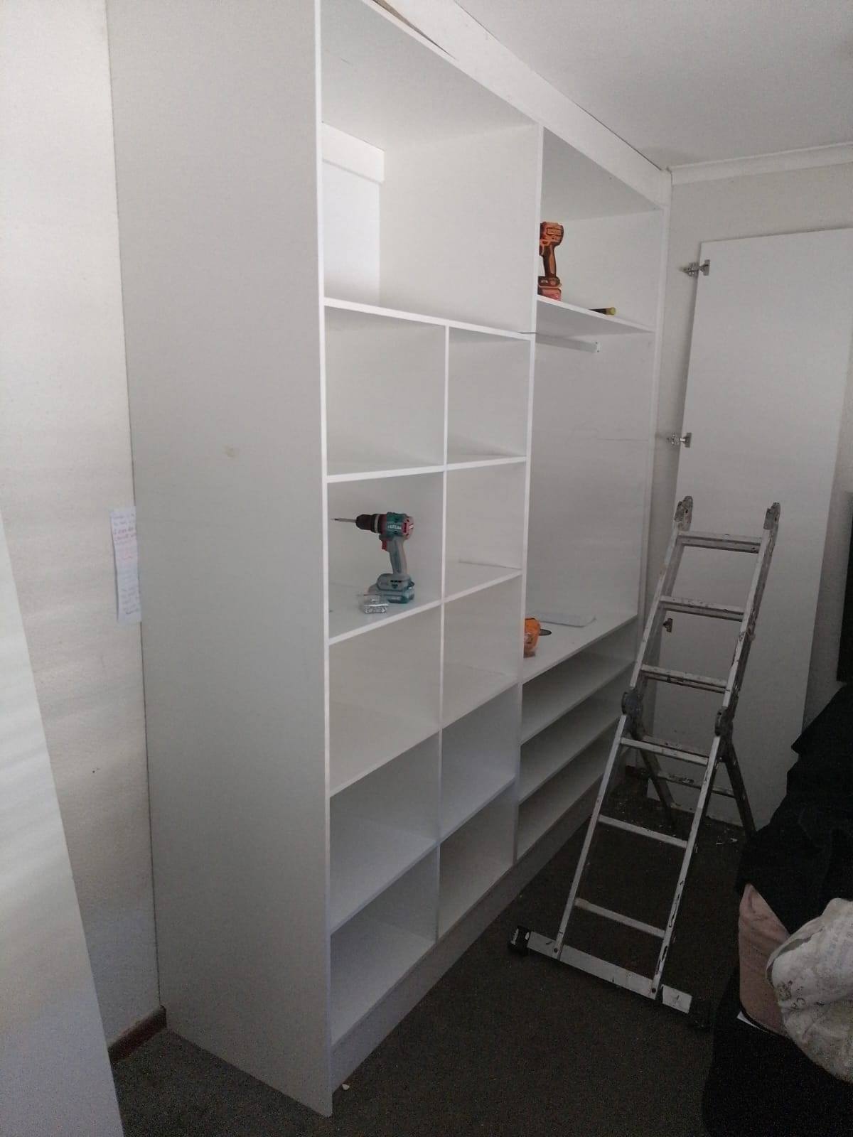 Closet shelving under construction with tools on site