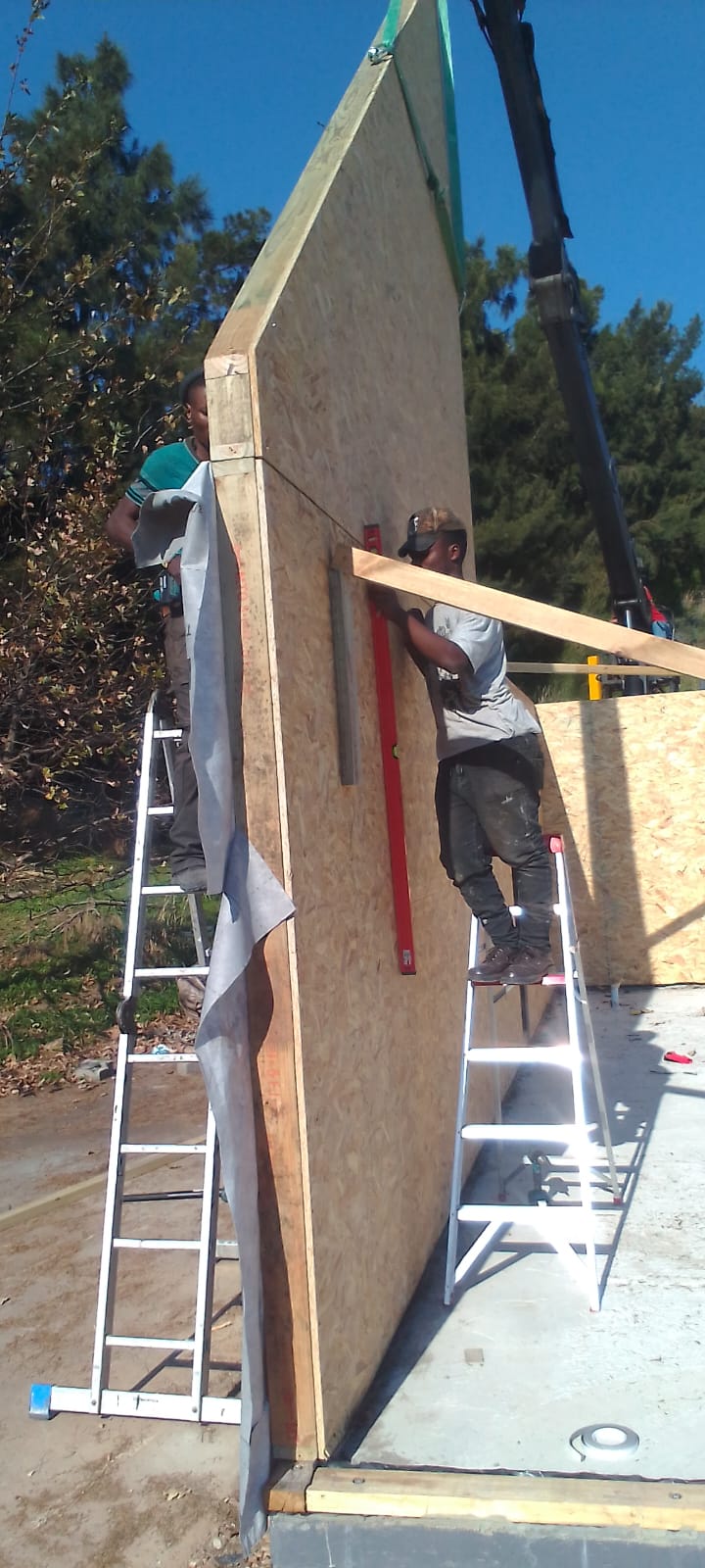 Workers installing large wall panel
