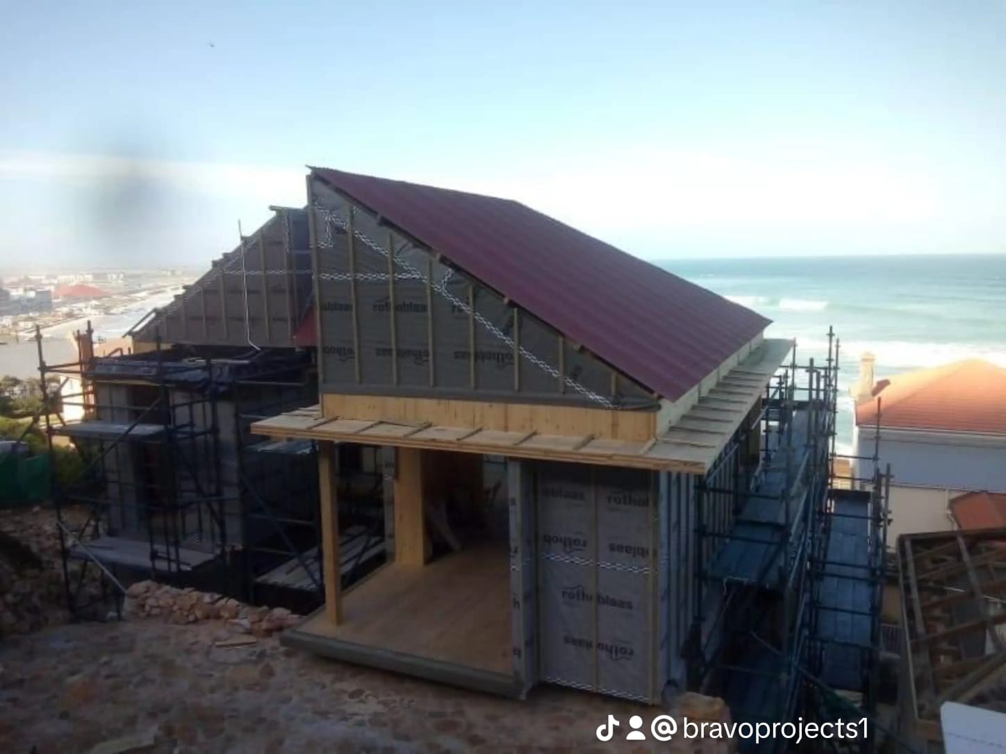 Beachfront building with purple roof and scaffolding