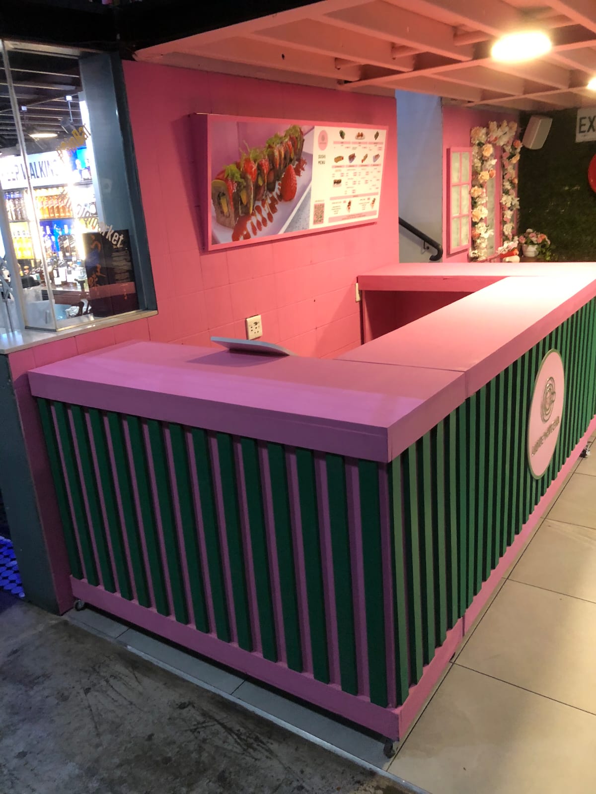 Sushi restaurant interior with pink and green accents