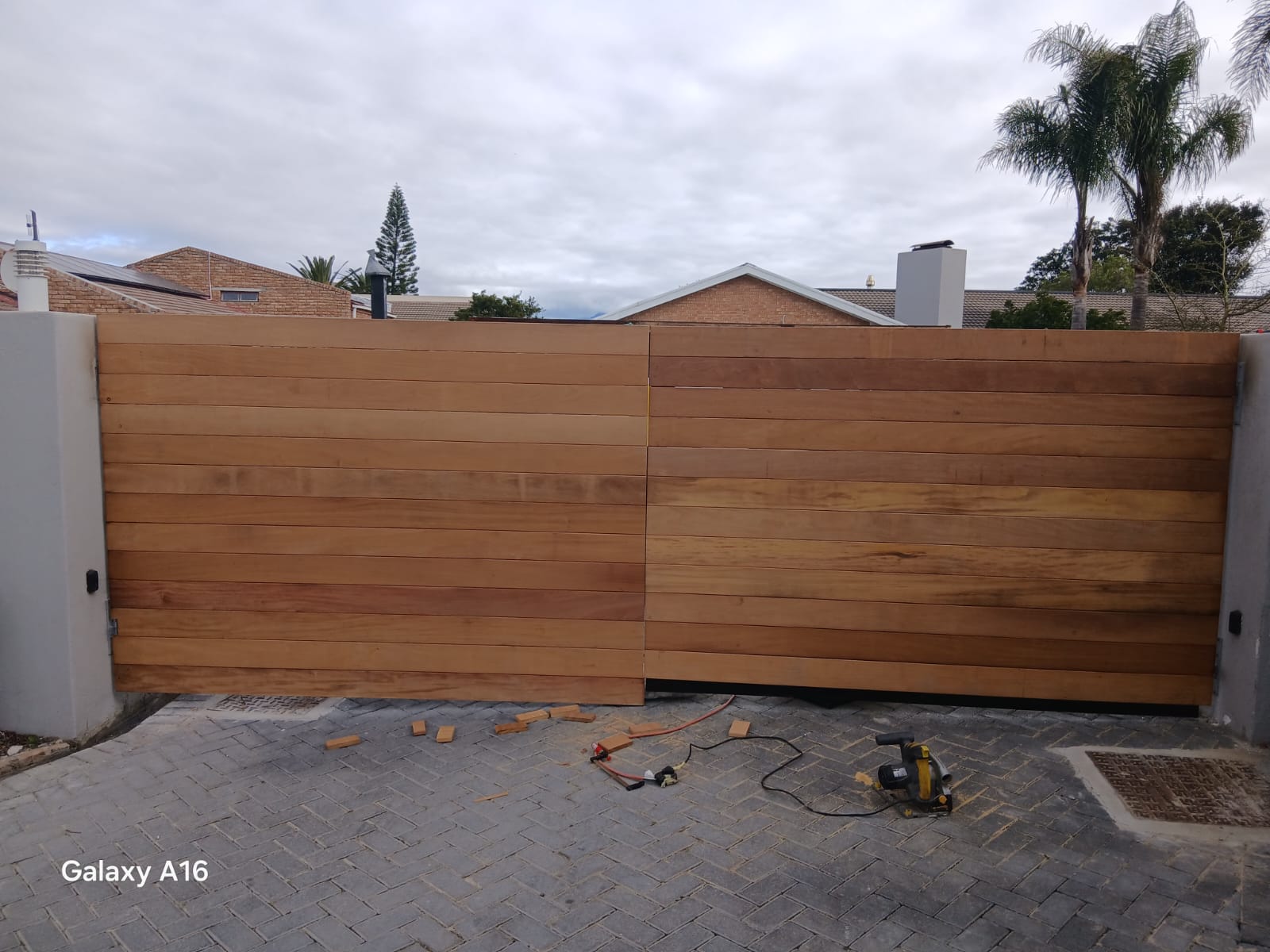 Modern wooden driveway gate installation