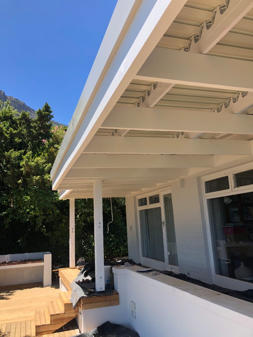Modern house with pergola and deck, mountain view