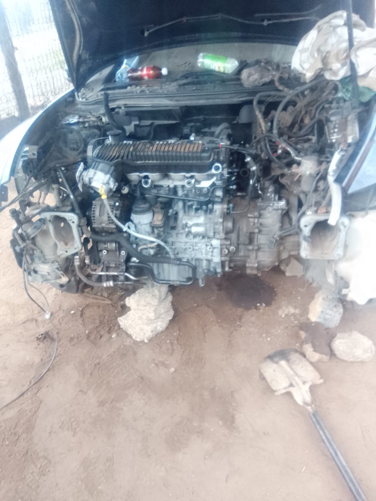 Open car engine compartment with partially disassembled engine and diagnostic lights