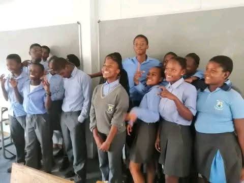 School children with teacher in classroom