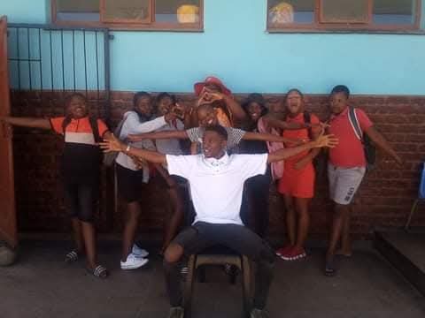 Children in red and black uniforms celebrating