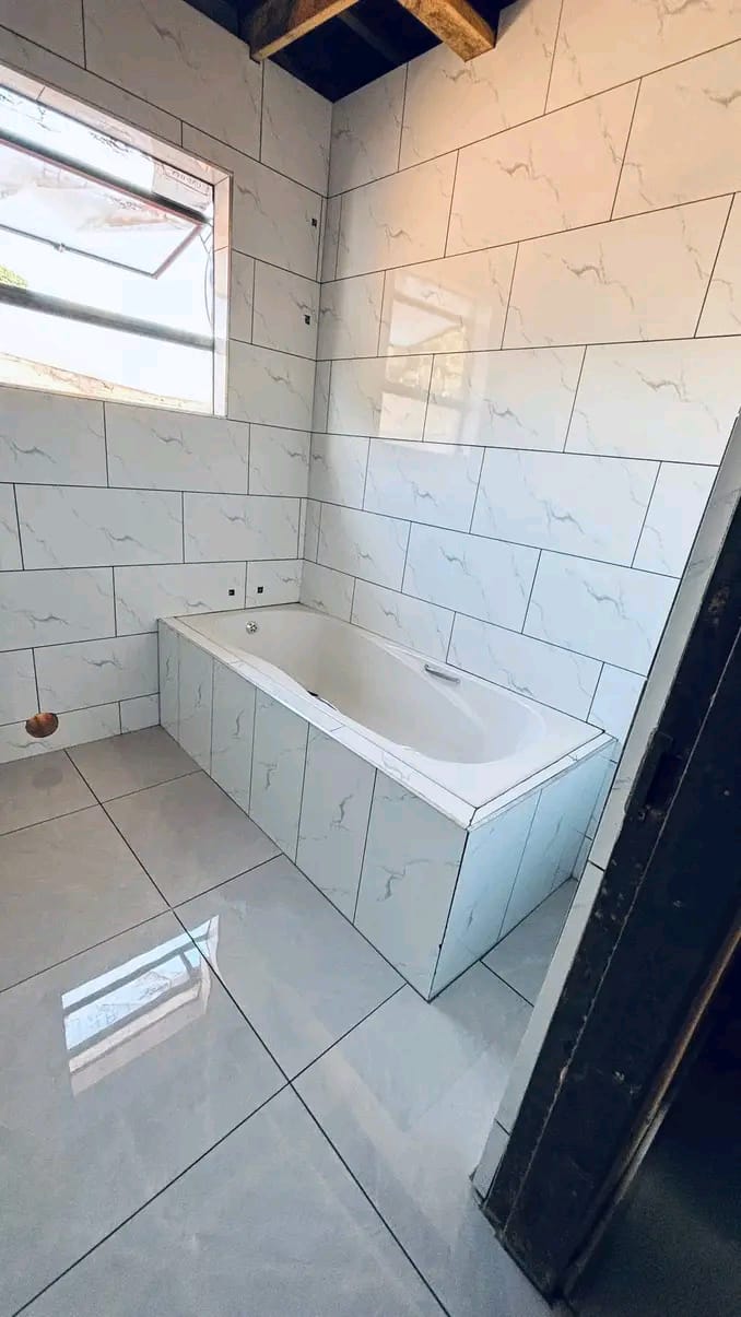 Newly renovated bathroom with marble-effect tiles