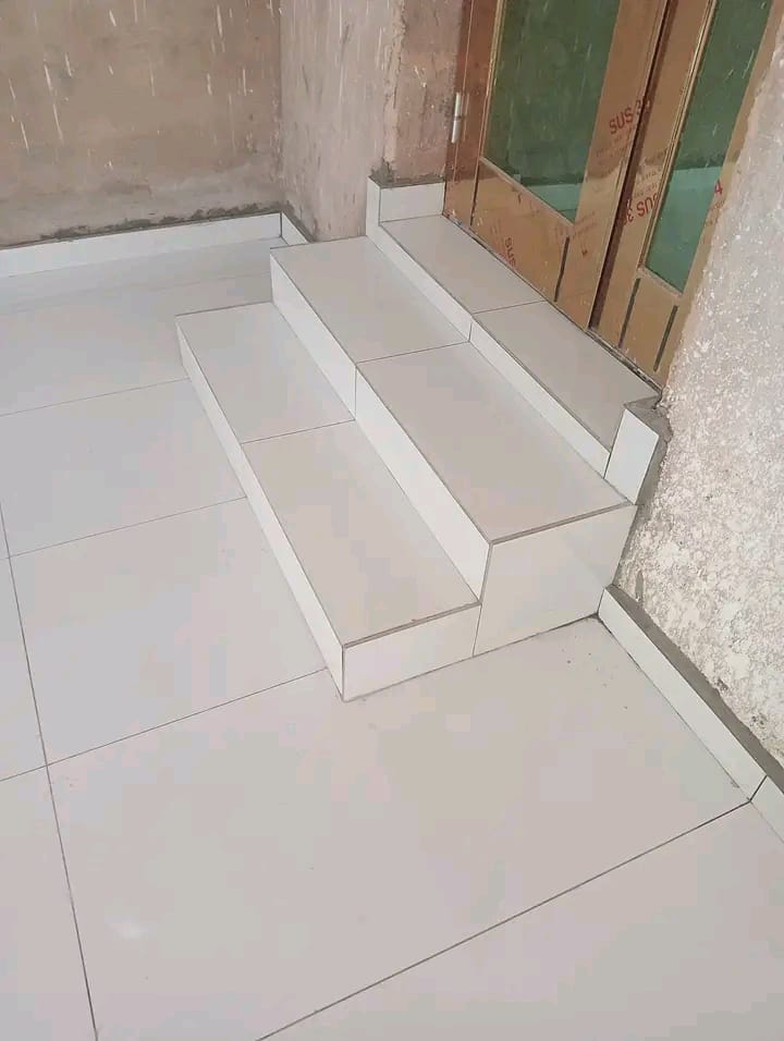 Interior construction space with white tiled floor and built-in bench units