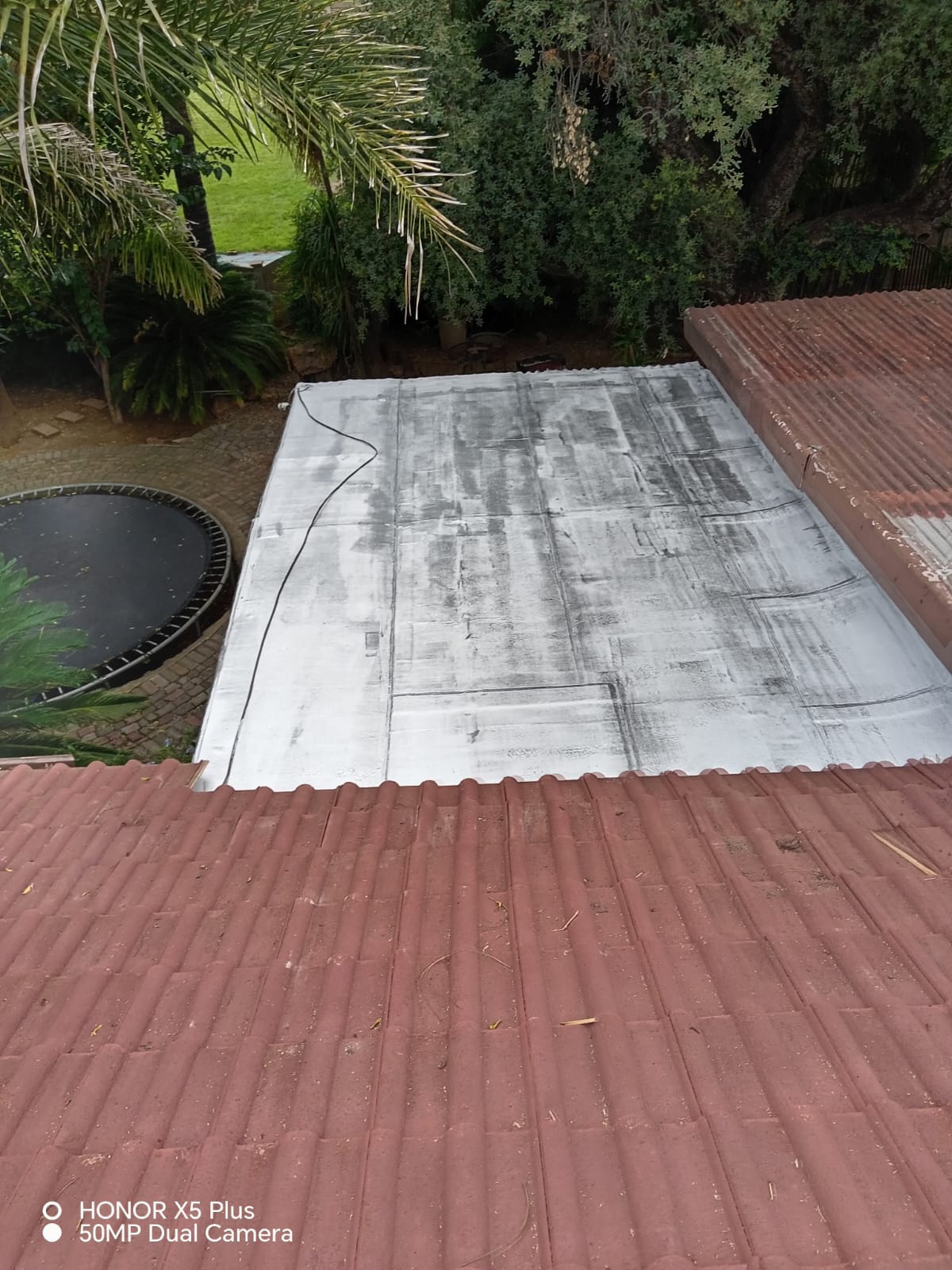 Solar panel installation on red corrugated metal roofing
