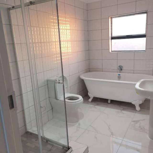 Modern finished bathroom with glass shower and claw-foot bathtub