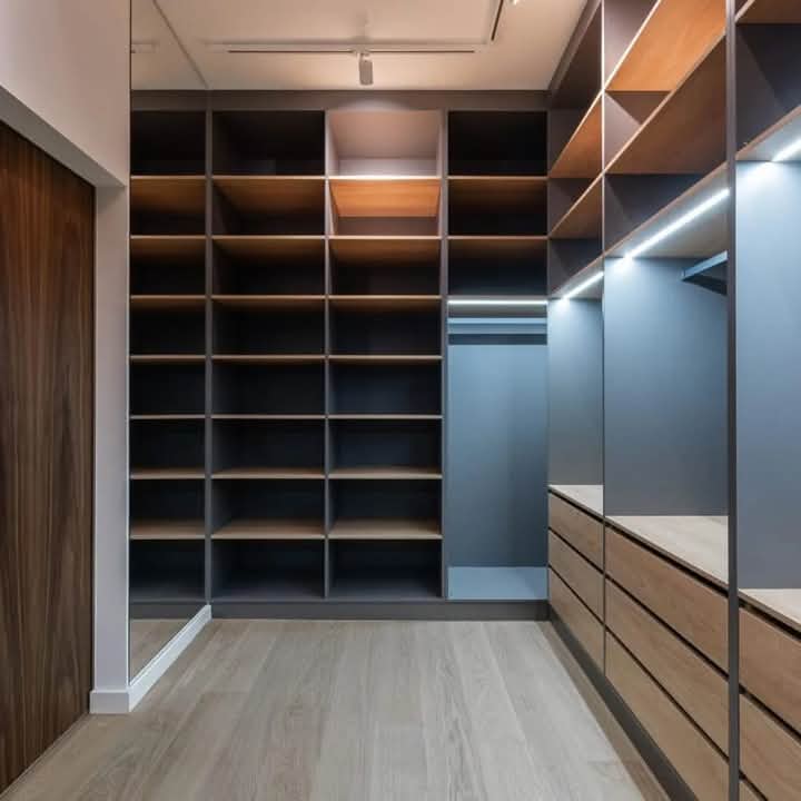 Walk-in closet with floor-to-ceiling shelving, accent lighting and mirror