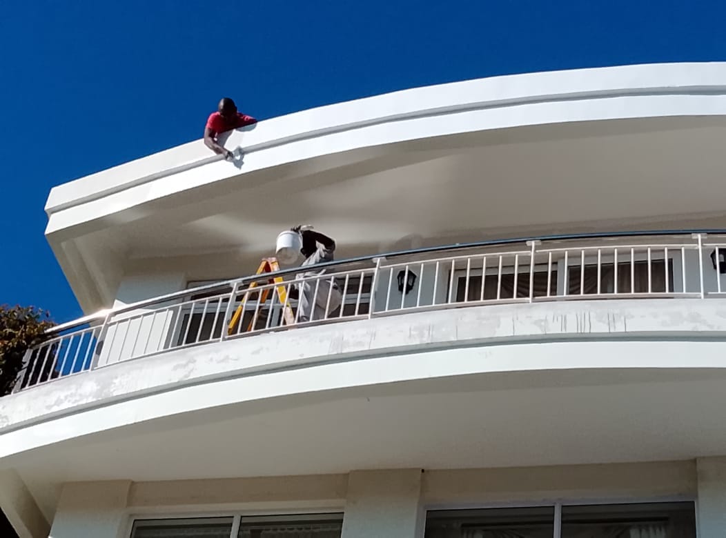 Modern curved white roof against a clear blue sky