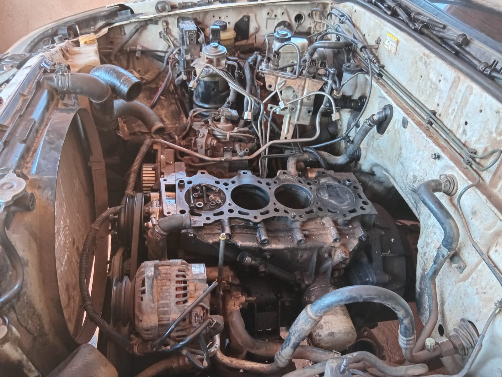 Disassembled engine block displaying exposed cylinders and mechanical components
