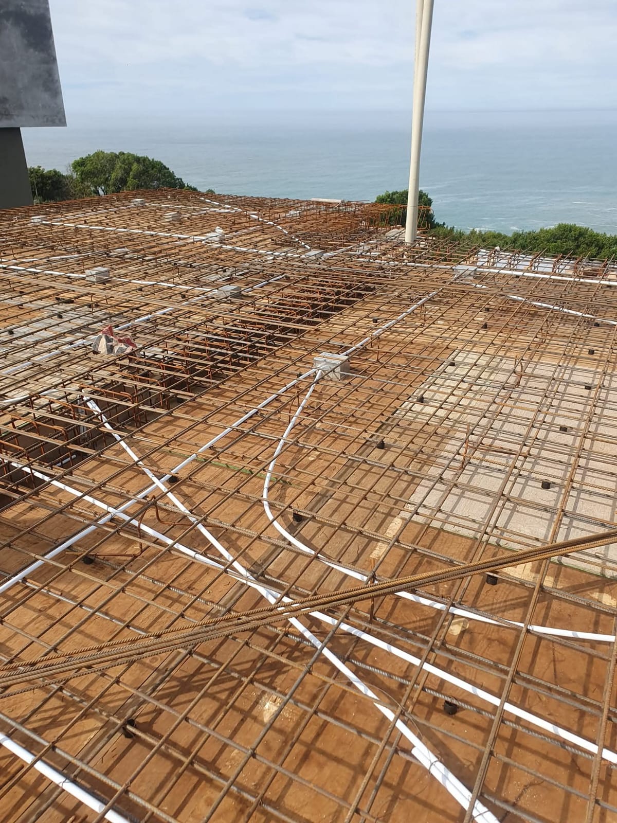 Coastal foundation with rebar on a cliff overlooking the ocean