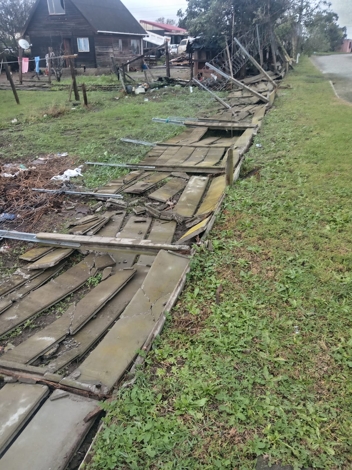Rural riverside site with deteriorated wooden boats and rustic dwellings
