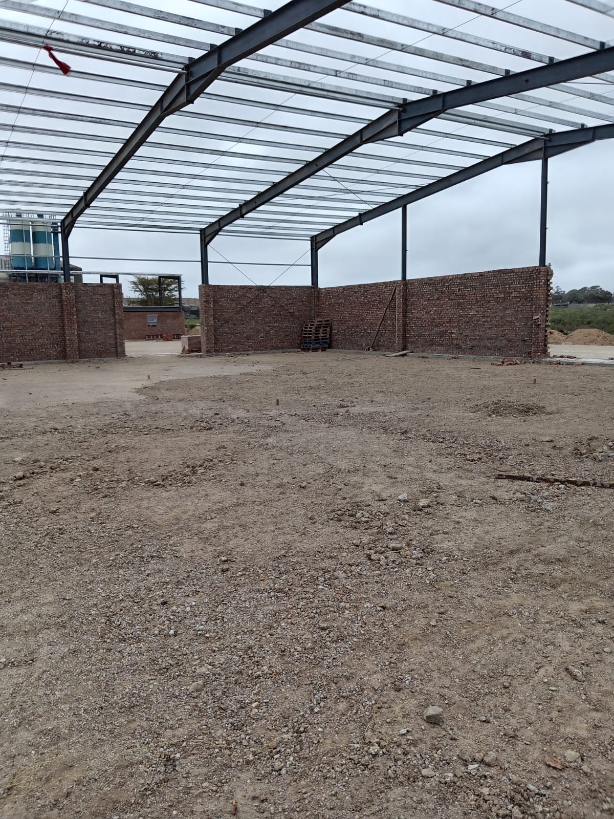 Agricultural building under construction with steel frame roof