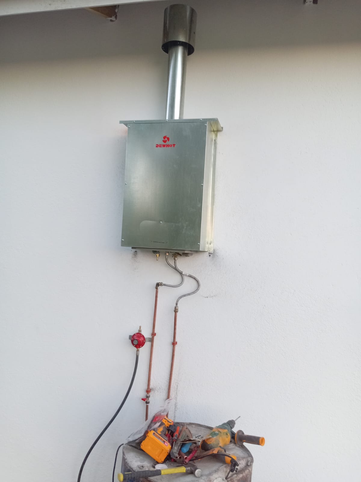 Wall-mounted gas boiler or water heater on white wall