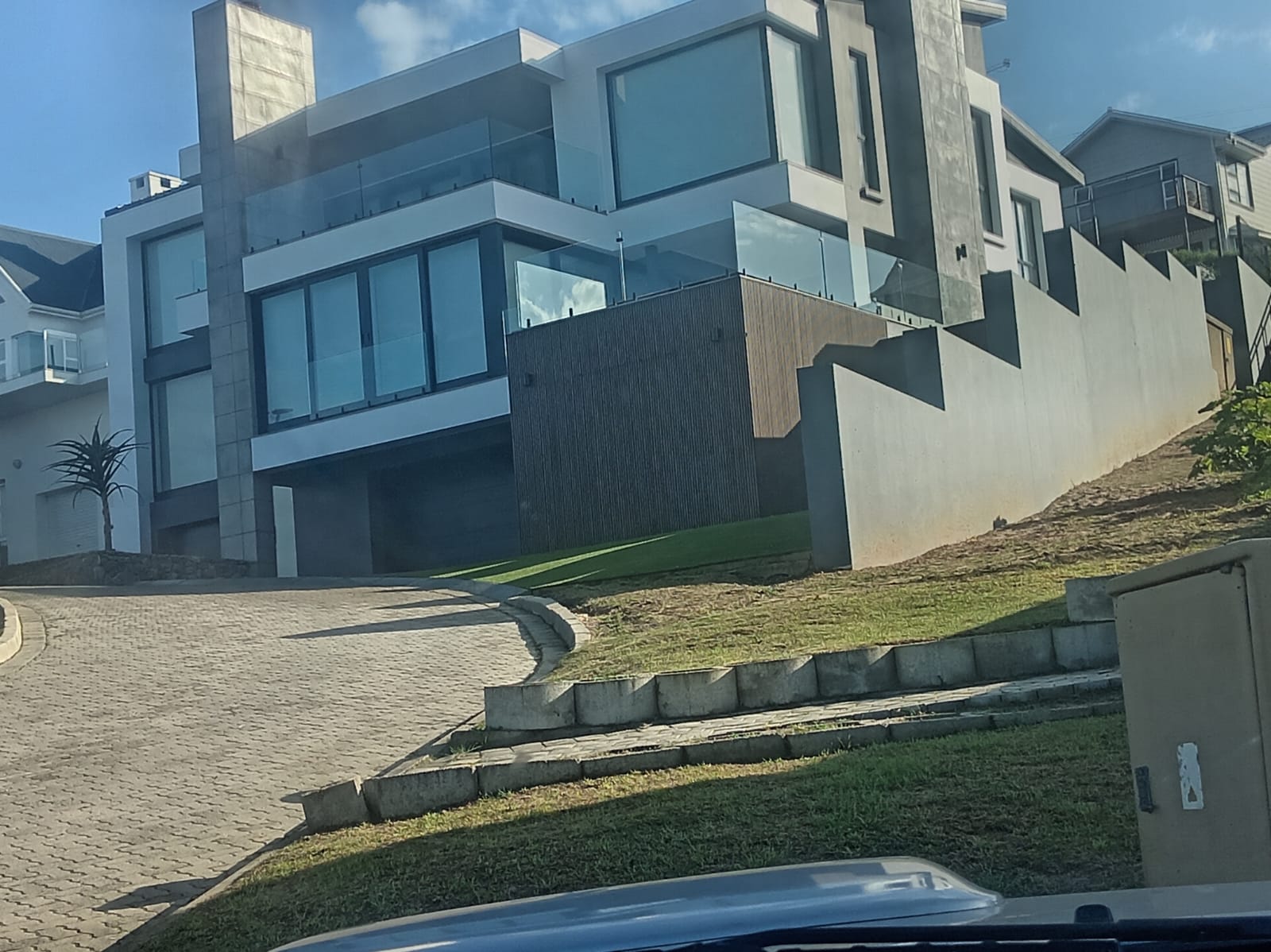 Modern multi-story residential building with dark wood accent