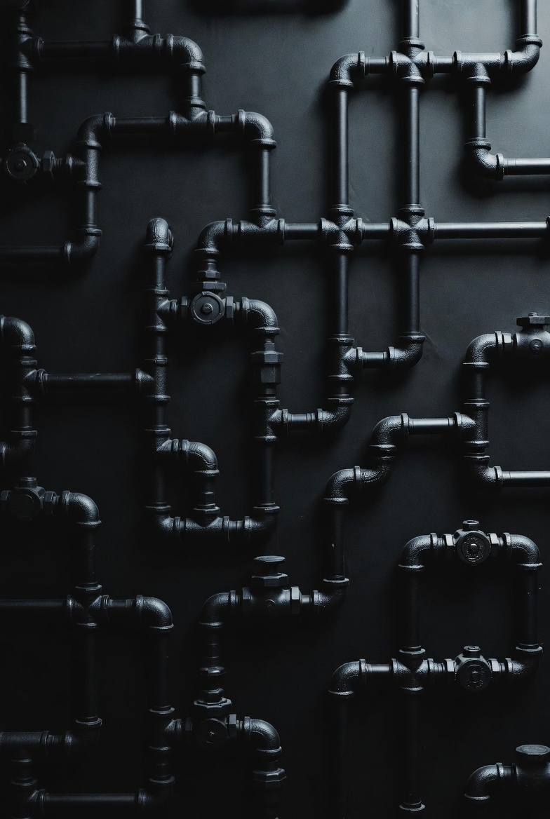 Professional plumber working on pipe installation