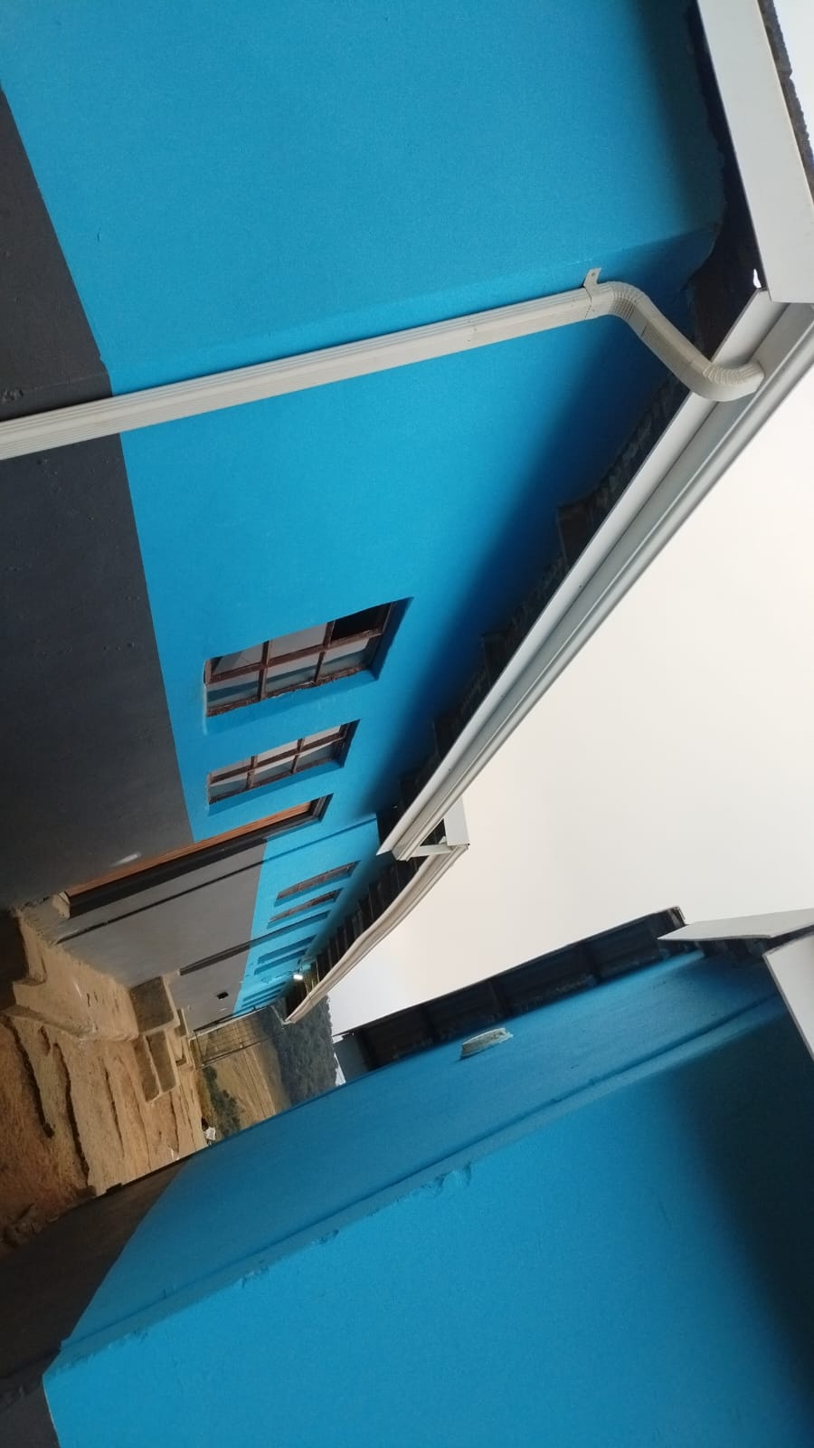 Turquoise blue building exterior with aluminium trim