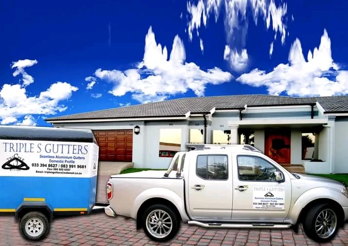 Triple S Gutters branded vehicle parked in front of a modern white home