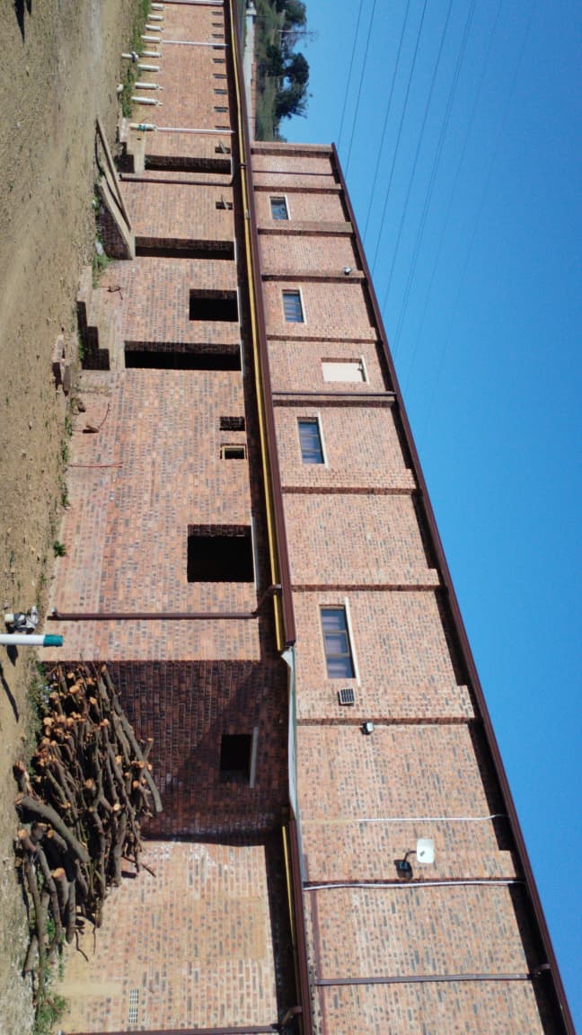 Tall brick residential building photographed at an angle