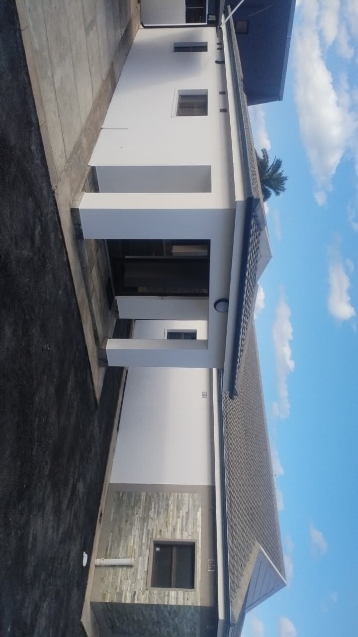 Modern two story white residential building with horizontal windows
