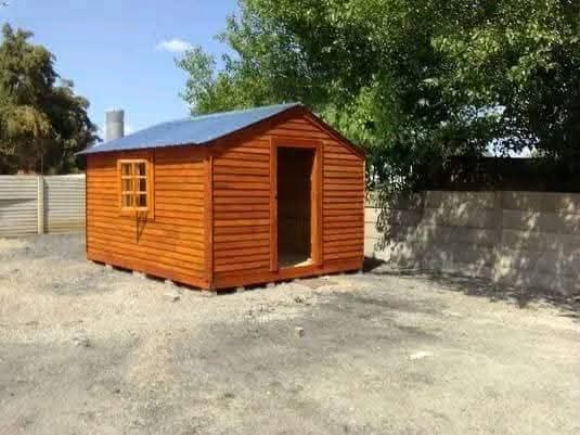 Bright orange wooden garden shed with blue metal roof in backyard