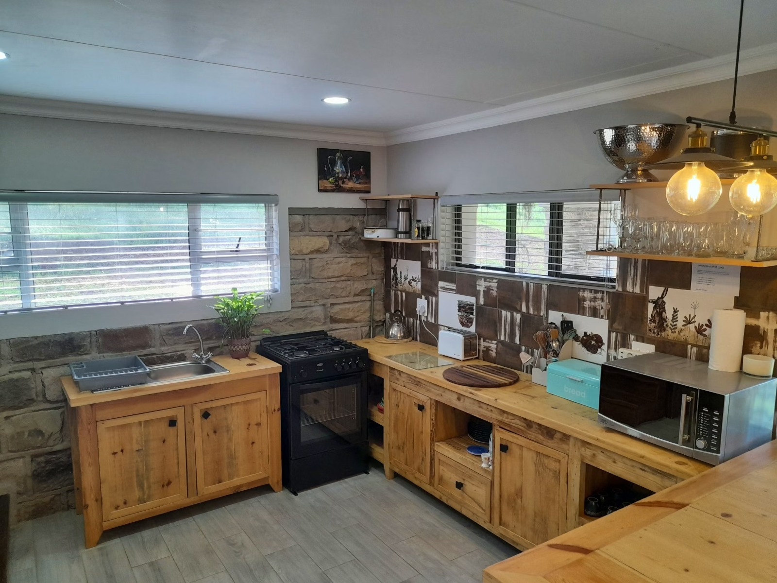 Modern kitchen with wooden cabinetry and stone backsplash