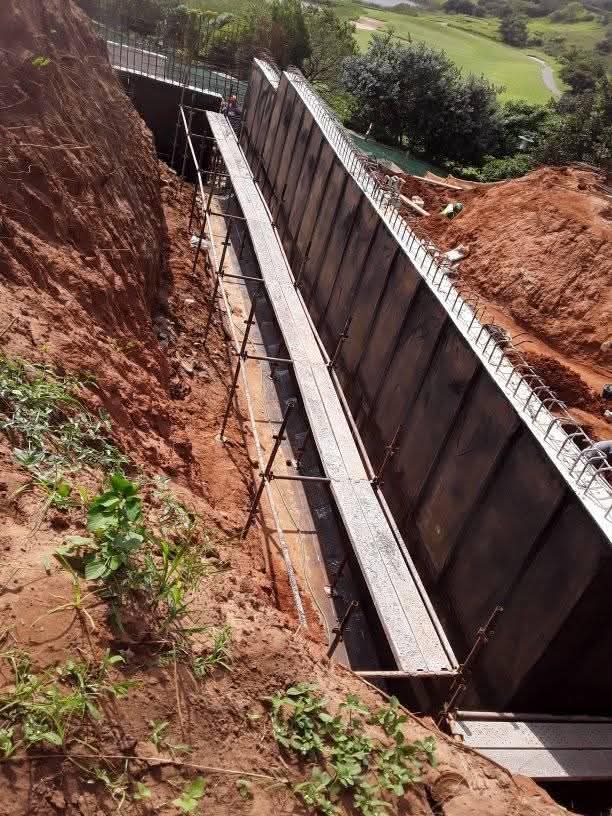 Retaining wall construction with concrete panels